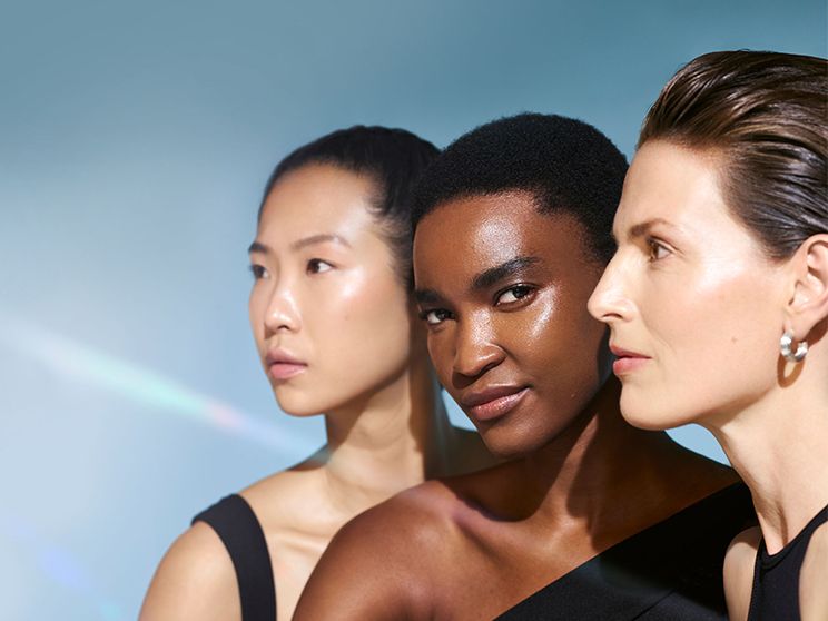 Three women wearing black, two looking to the right and one looking at the camera